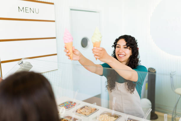 istock Smiling young woman worker serving ice cream cones 1496724463