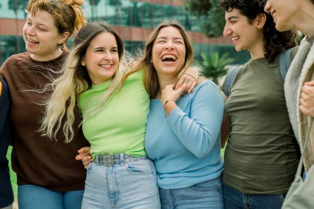 istock Group of diverse student friends hugging and laughing 1496726530