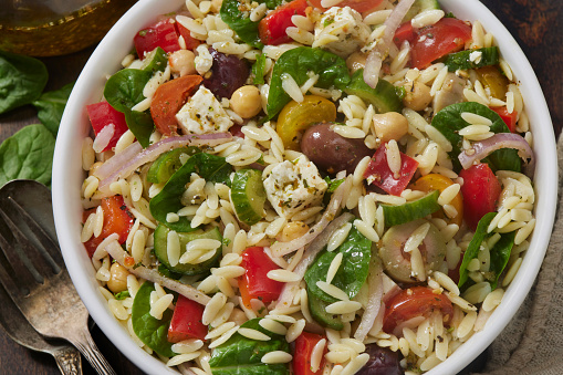 Mediterranean Orzo Salad with Baby Spinach, Feta, Cherry Tomatoes, Cucumber, Olives, Red Onion, Red Peppers and Chick Peas