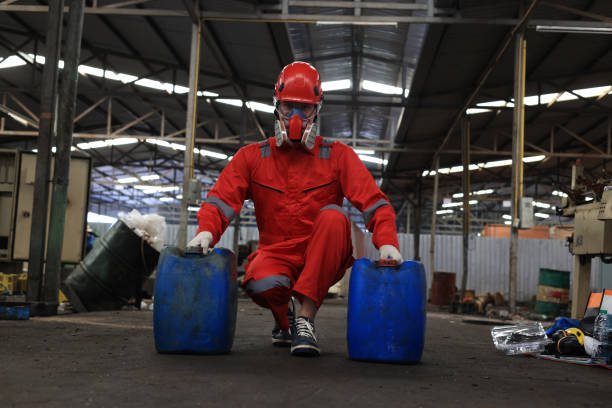 istock Worker maintenance  or scientist industry wearing protective safety uniform, white glove and gas mask to work with a  two barrel of oil. 1496731799
