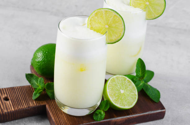 istock Brazilian Lemonade, Refreshing Creamy Lemonade or Limeade with Lime Slices and Mint on Grey Background 1496734177