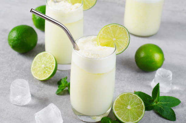 istock Brazilian Lemonade, Refreshing Creamy Lemonade or Limeade with Lime Slices and Mint on Grey Background 1496734920