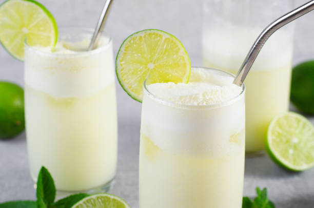 istock Brazilian Lemonade, Refreshing Creamy Lemonade or Limeade with Lime Slices and Mint on Grey Background 1496735250