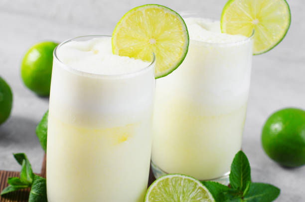 istock Brazilian Lemonade, Refreshing Creamy Lemonade or Limeade with Lime Slices and Mint on Grey Background 1496735334