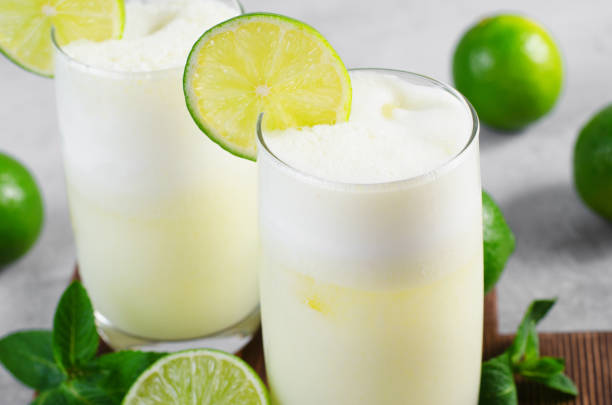 istock Brazilian Lemonade, Refreshing Creamy Lemonade or Limeade with Lime Slices and Mint on Grey Background 1496735392
