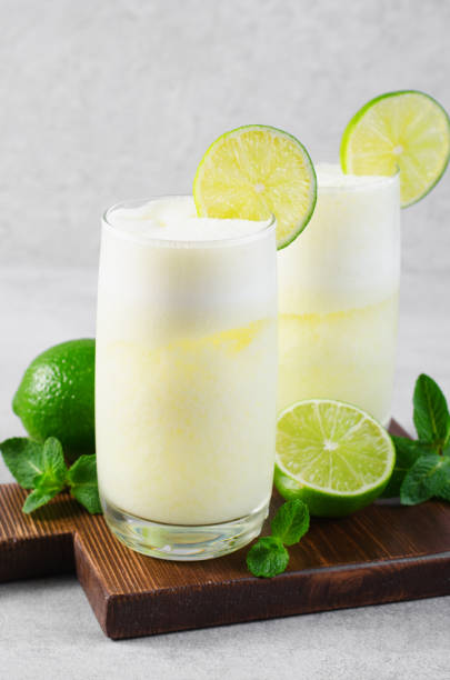 istock Brazilian Lemonade, Refreshing Creamy Lemonade or Limeade with Lime Slices and Mint on Grey Background 1496735451