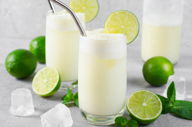 istock Brazilian Lemonade, Refreshing Creamy Lemonade or Limeade with Lime Slices and Mint on Grey Background 1496735483