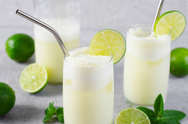 istock Brazilian Lemonade, Refreshing Creamy Lemonade or Limeade with Lime Slices and Mint on Grey Background 1496735652