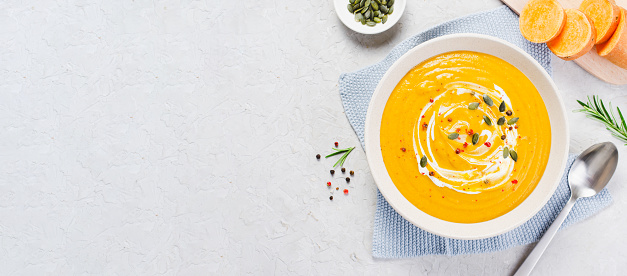 Sweet Potato Soup, Tasty Homemade Pumpkin, Sweet Potato, Carrot Soup in a Bowl on Bright Background