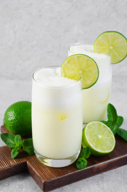 istock Brazilian Lemonade, Refreshing Creamy Lemonade or Limeade with Lime Slices and Mint on Grey Background 1496736136