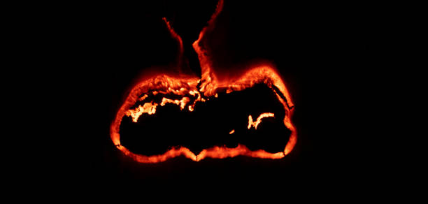 istock burning paper, glowing edge of paper on a black background 1496736669