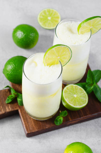 istock Brazilian Lemonade, Refreshing Creamy Lemonade or Limeade with Lime Slices and Mint on Grey Background 1496736770