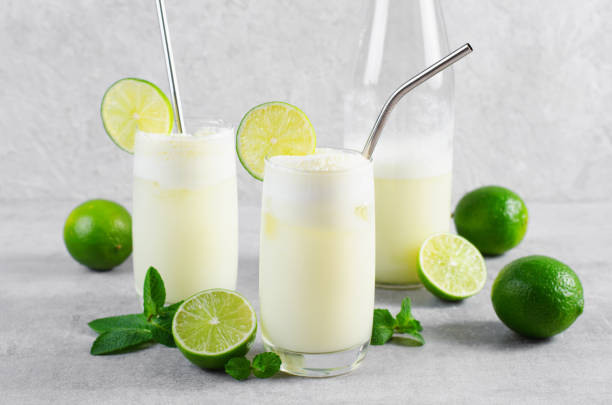 istock Brazilian Lemonade, Refreshing Creamy Lemonade or Limeade with Lime Slices and Mint on Grey Background 1496736777
