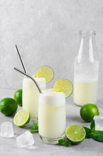 istock Brazilian Lemonade, Refreshing Creamy Lemonade or Limeade with Lime Slices and Mint on Grey Background 1496736785