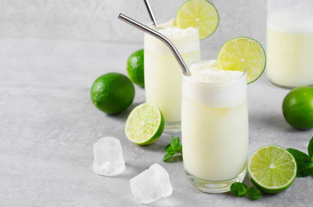 istock Brazilian Lemonade, Refreshing Creamy Lemonade or Limeade with Lime Slices and Mint on Grey Background 1496736880