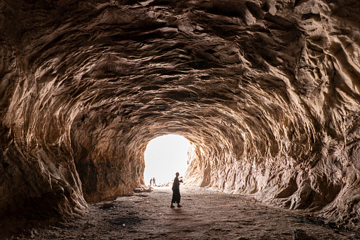 A young person taking a photo from a massive Mine Cave in Garmsar of Iran