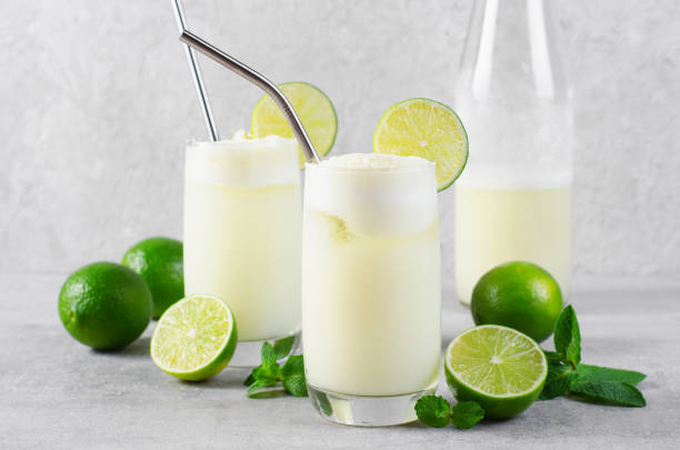 istock Brazilian Lemonade, Refreshing Creamy Lemonade or Limeade with Lime Slices and Mint on Grey Background 1496736944