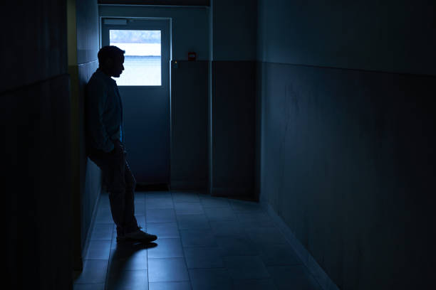 istock Figure of man standing in darkness and waiting 1496737628