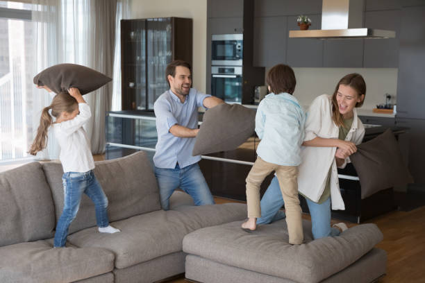 istock Energetic little kids and cheerful parents playing active games 1496738541