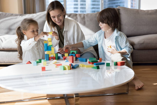 istock Cheerful young daycare teacher, nanny playing smart game 1496738556