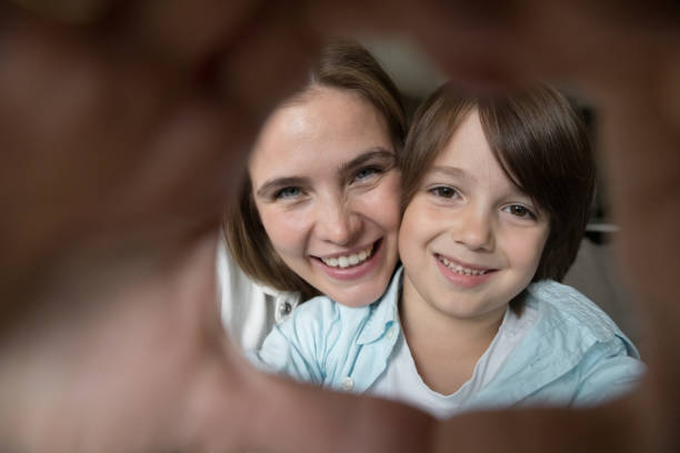 istock Happy pretty little son and young mother looking at camera 1496738893