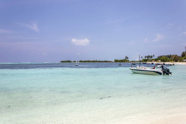 A white sand beach on Fulidhoo with moored boats