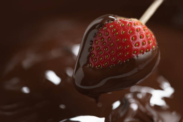 dipping strawberry into dark premium chocolate dipping strawberry into dark premium chocolate, with copy space chocolate fingers stock pictures, royalty-free photos & images