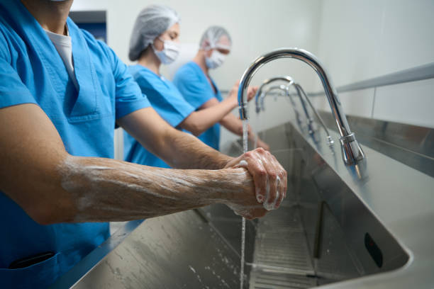 istock Team of surgeons thoroughly washes their hands before surgery 1496741273
