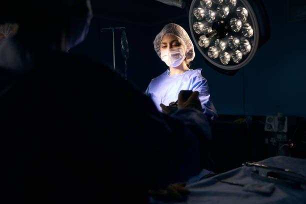 istock Woman in a surgical uniform stands at the operating table 1496741308