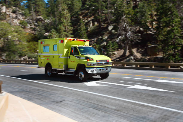 istock Yellow First Responder Ambulance racing down a mountain road with lights flashing. 1496743782