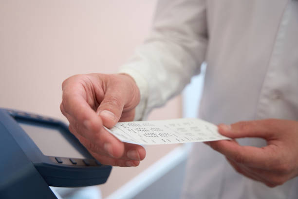 istock Image of unrecognized male with bill near the modern office machine 1496743920