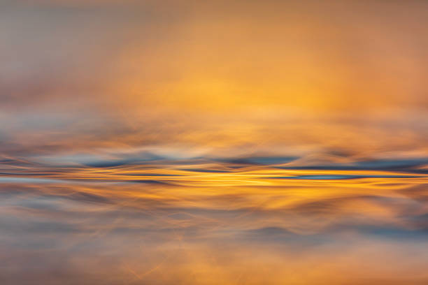 istock Abstract surface tension and natural patterns on water with golden light 1496744148