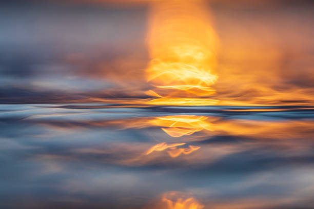 istock Abstract surface tension and natural patterns on water with golden light 1496744333