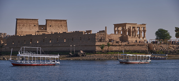 Felucca by the Temple of Philae on the Agilikia island, the Nile, Aswan, Egypt.