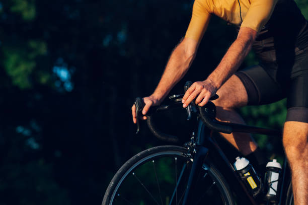 istock Unrecognizable man holding handlebars on his bike during a race outside 1496744671