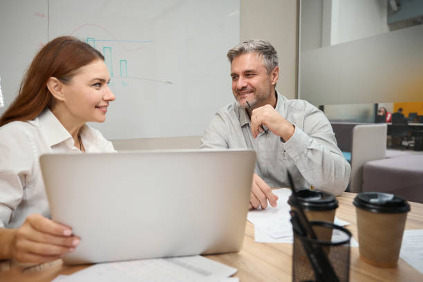 istock Young female talking with man in the office 1496746015
