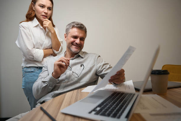 istock Male working in office, looking at contract 1496746078