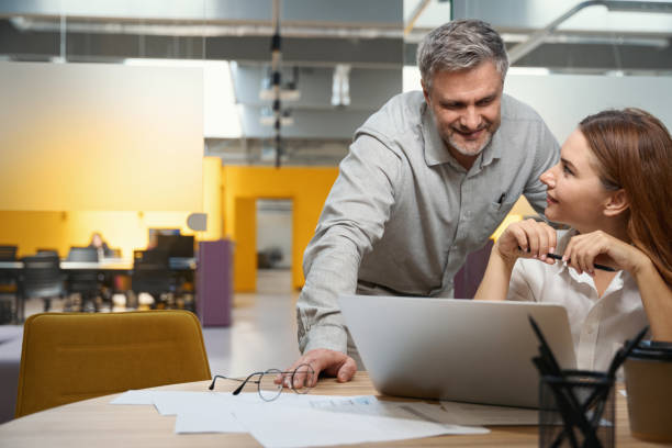 istock Male and female discussing work process in the office 1496746080