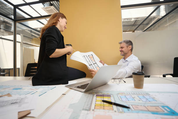 istock Professional architect and female working with documents in coworking 1496746118