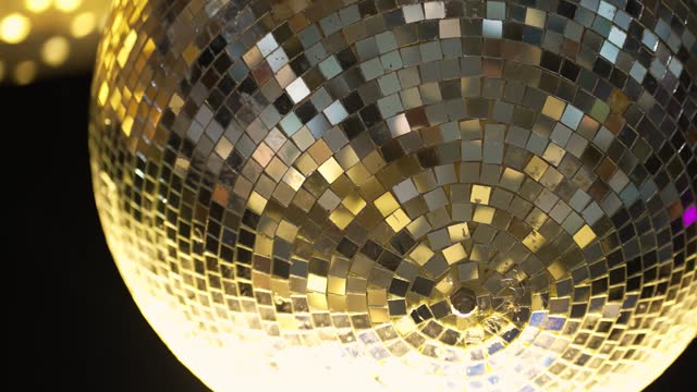 Disco ball with bright rays at night party