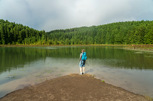 One women standing at the water edge of Seven Cities Lagoon, Sao Miguel, Azores island