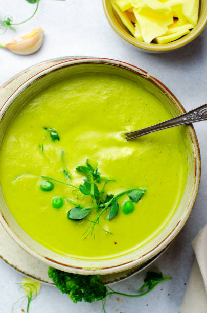 istock Pea Soup with Green Vegetables, Broccoli and Pea Sprounts with cheese on bright backround 1496750903