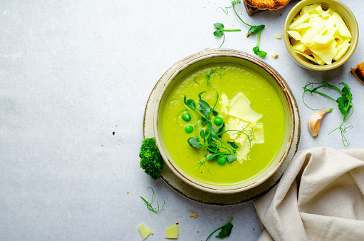 Pea Soup with Green Vegetables, Broccoli and Pea Sprounts with cheese on bright backround, Healthy Eating