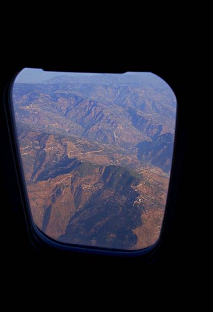 istock View of mountain range seen through an airplane window during sunset 1496751421