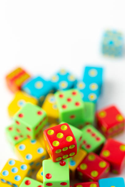 istock Pile of Multi-Colored Dice on a White Background; Red Dice with Five Pips on Top in Focus 1496751600