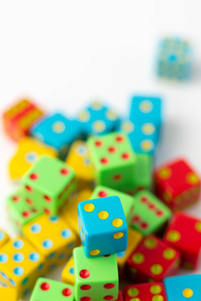 istock Pile of Multi-Colored Dice on a White Background; Blue Dice with Three Pips on Top in Focus 1496751604