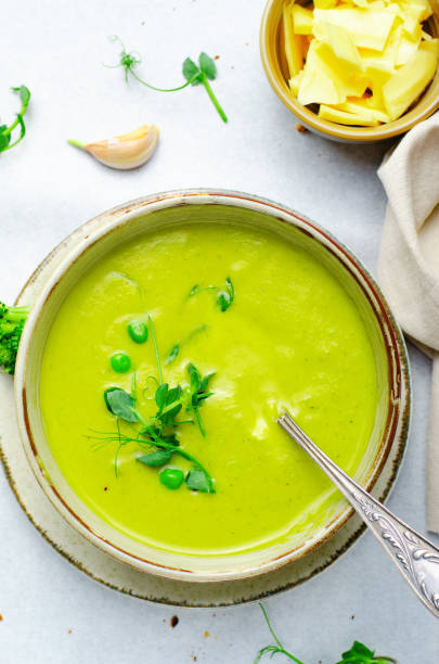 istock Pea Soup with Green Vegetables, Broccoli and Pea Sprounts with cheese on bright backround 1496752858