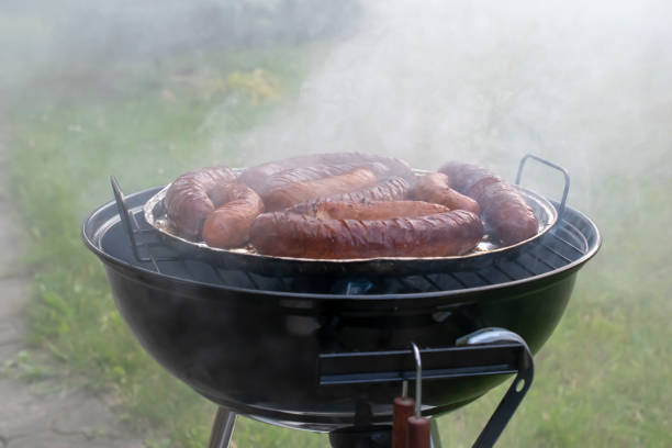 grilling sausages, garden charcoal grill