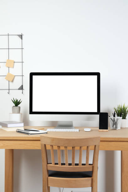 istock Cozy workspace with computer and stationery on wooden desk at home 1496754009