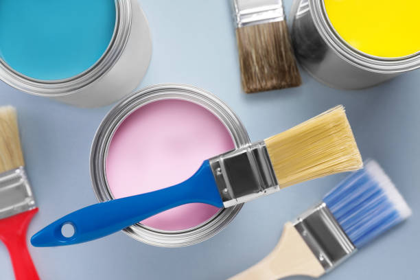 istock Cans with colorful paints and brushes on light background, flat lay 1496754223